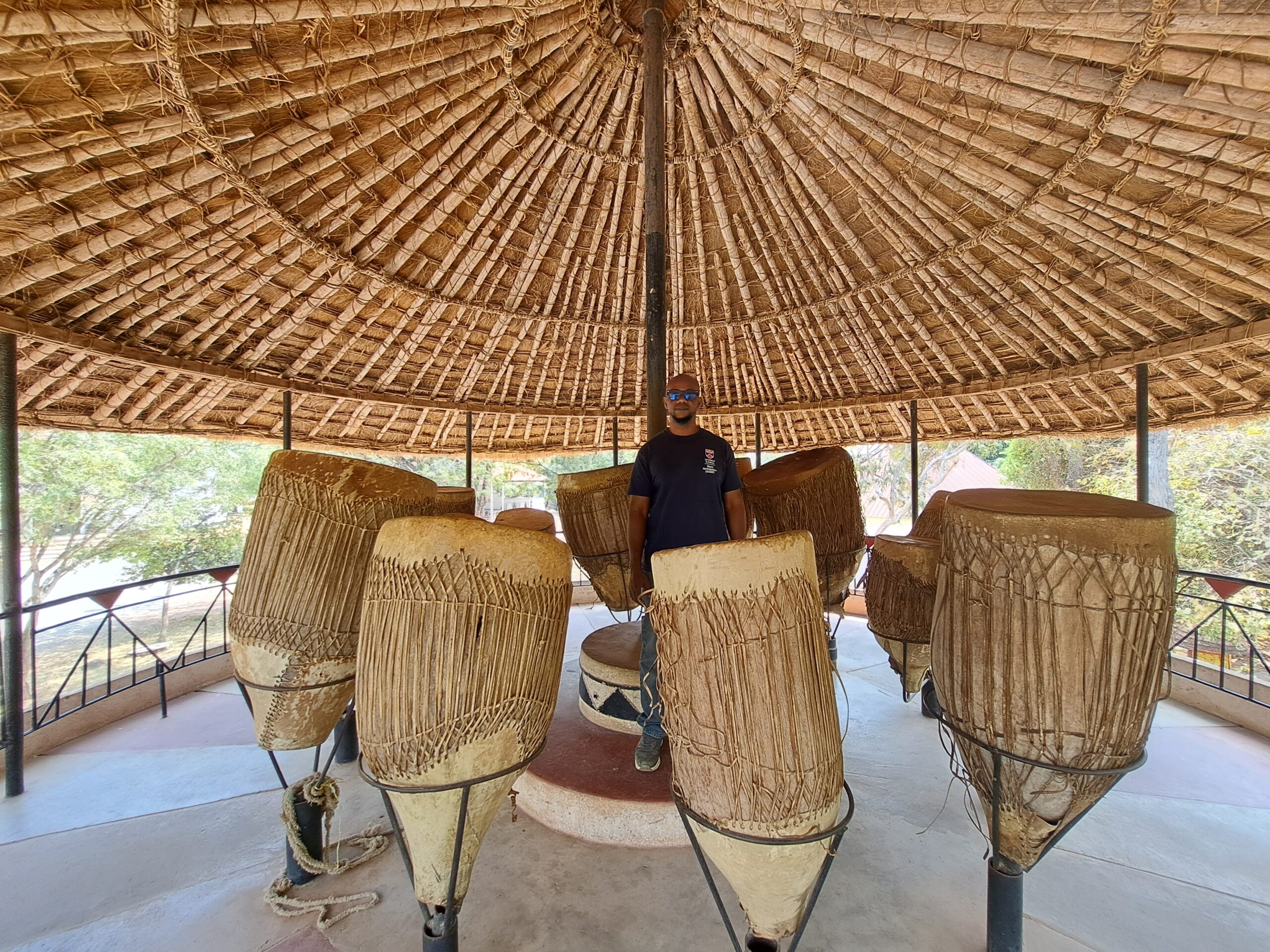 Baraka Issabu among the ngoma drums at Bujora Cultural Centre, Kisesa